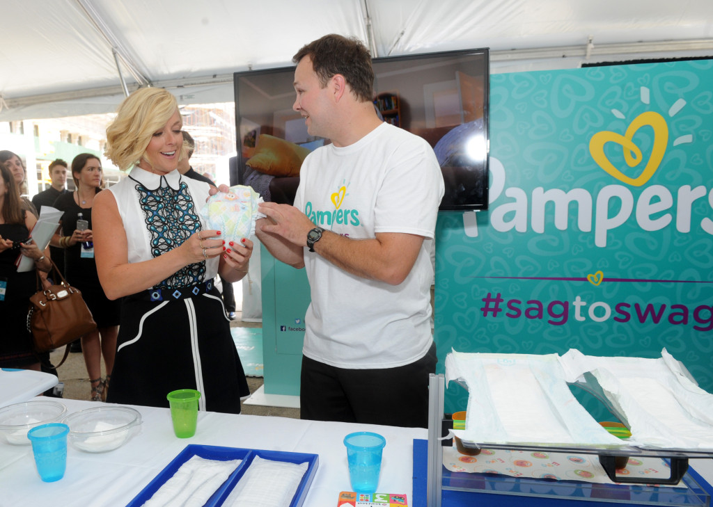 Actress and mom Jane Krakowski learns about the new and improved Pampers Cruisers diapers from Scott Reese, of Pampers, at the launch of the Pampers Cruisers #SagToSwag Tour in New York, Wednesday, Aug. 12, 2015.  Pampers is going on a national tour to transform the nationÕs babies from Òsag to swagÓ by helping to prevent diaper sag . (Photo by Diane Bondareff/Invision for Pampers/AP Images)
